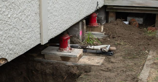 Jack and pack re-levelling work being carried out under a Christchurch home